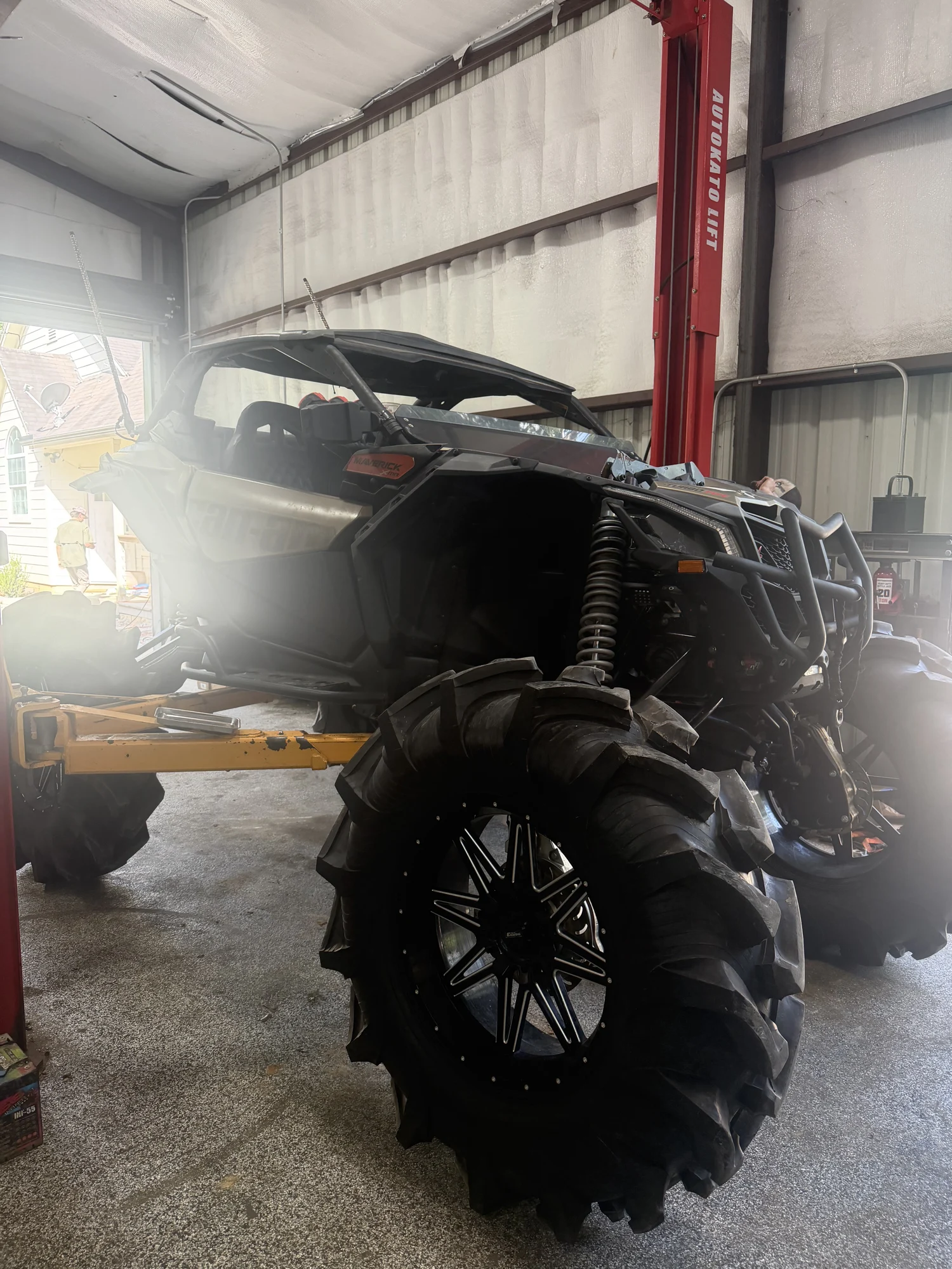 Can-Am Maverick with large off-road tires inside the Sovereign workshop
